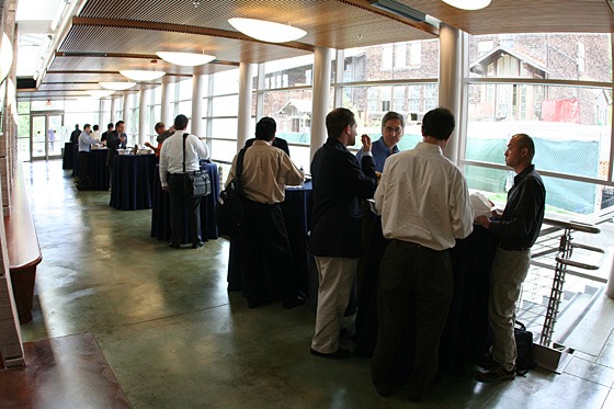 The Kvamme Atrium in Sutardja Dai Hall, with people standing at round cafe tables.