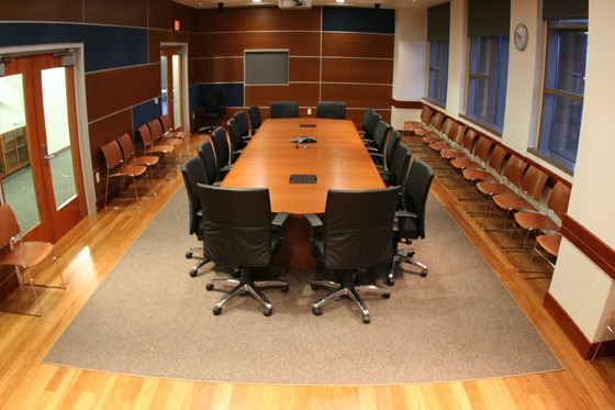The Bechtel Boardroom in Sutardja Dai Hall, with 16 chairs around a long table and several more chairs around the perimeter of the room.